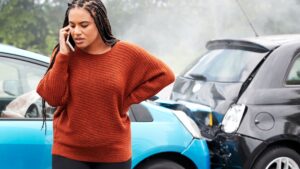 A woman calling her insurance after a car accident.