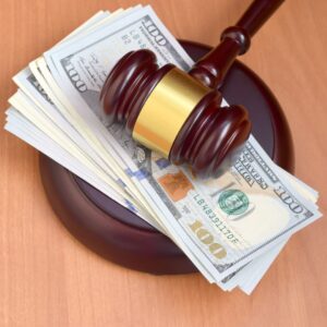 a gavel on top of a stack of money