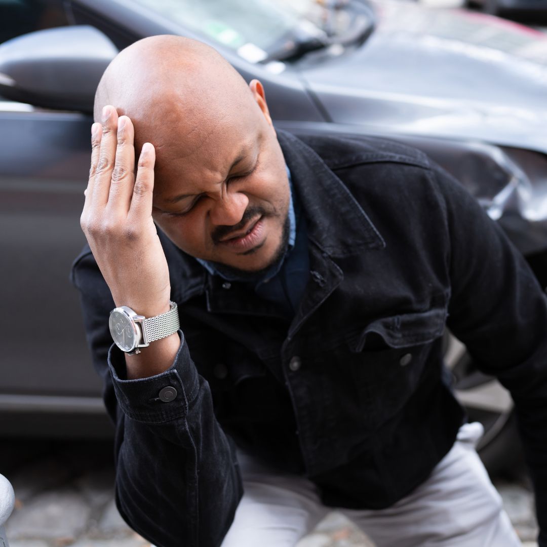 man touching head injured from car accident