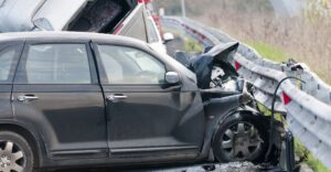 a car accident between two vehicles involving a shoulder barrier