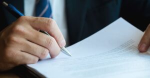 a person signing paperwork