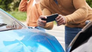 Man documenting images of accident damage