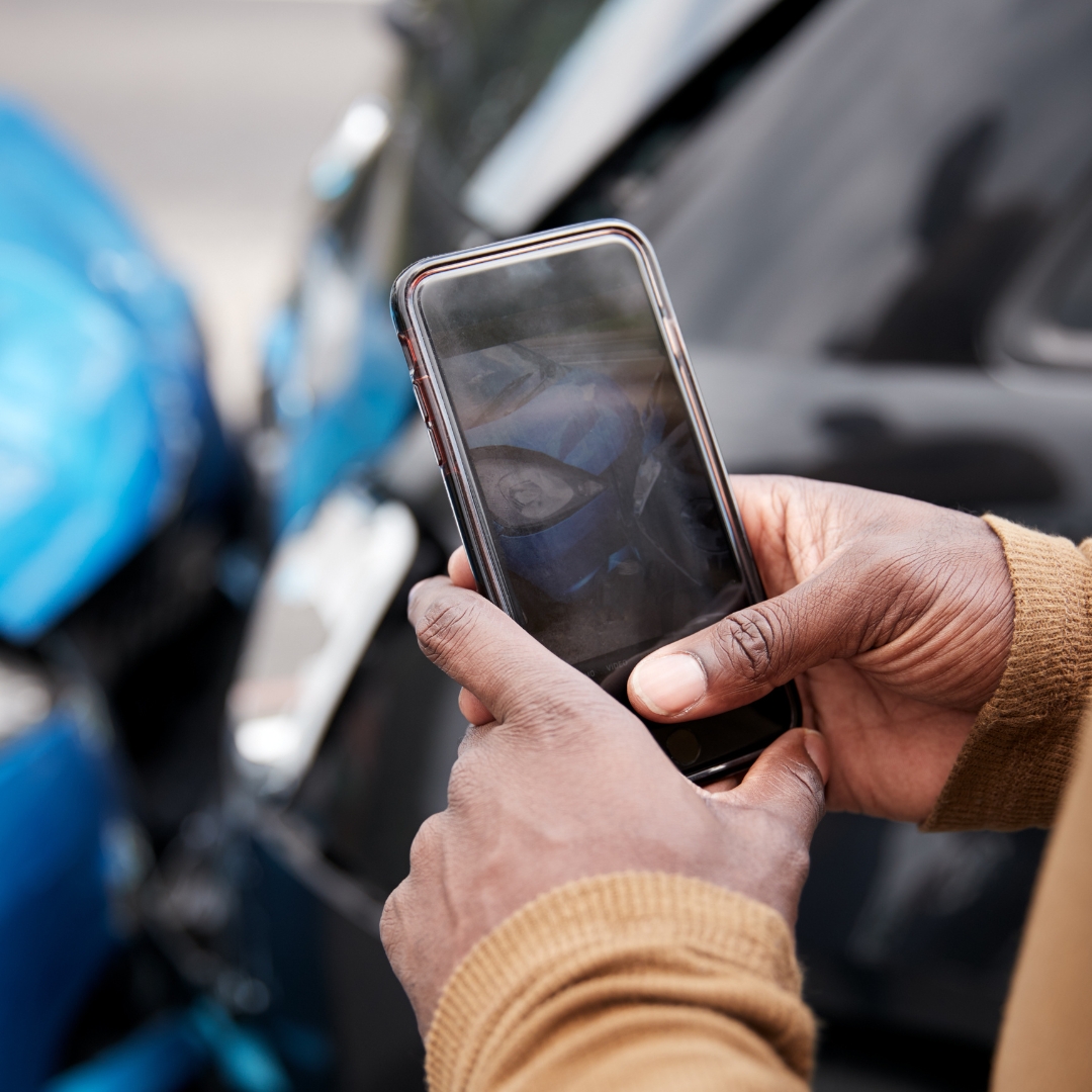 Man documenting images of accident damage