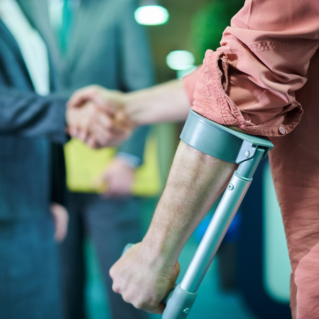 Injured man shaking hands with his lawyer