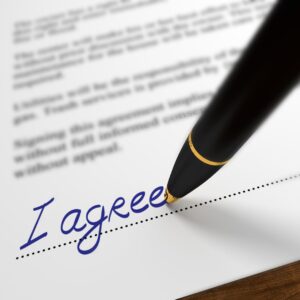 paperwork being signed "I agree"
