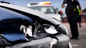 Policeman approaching a wrecked vehicle