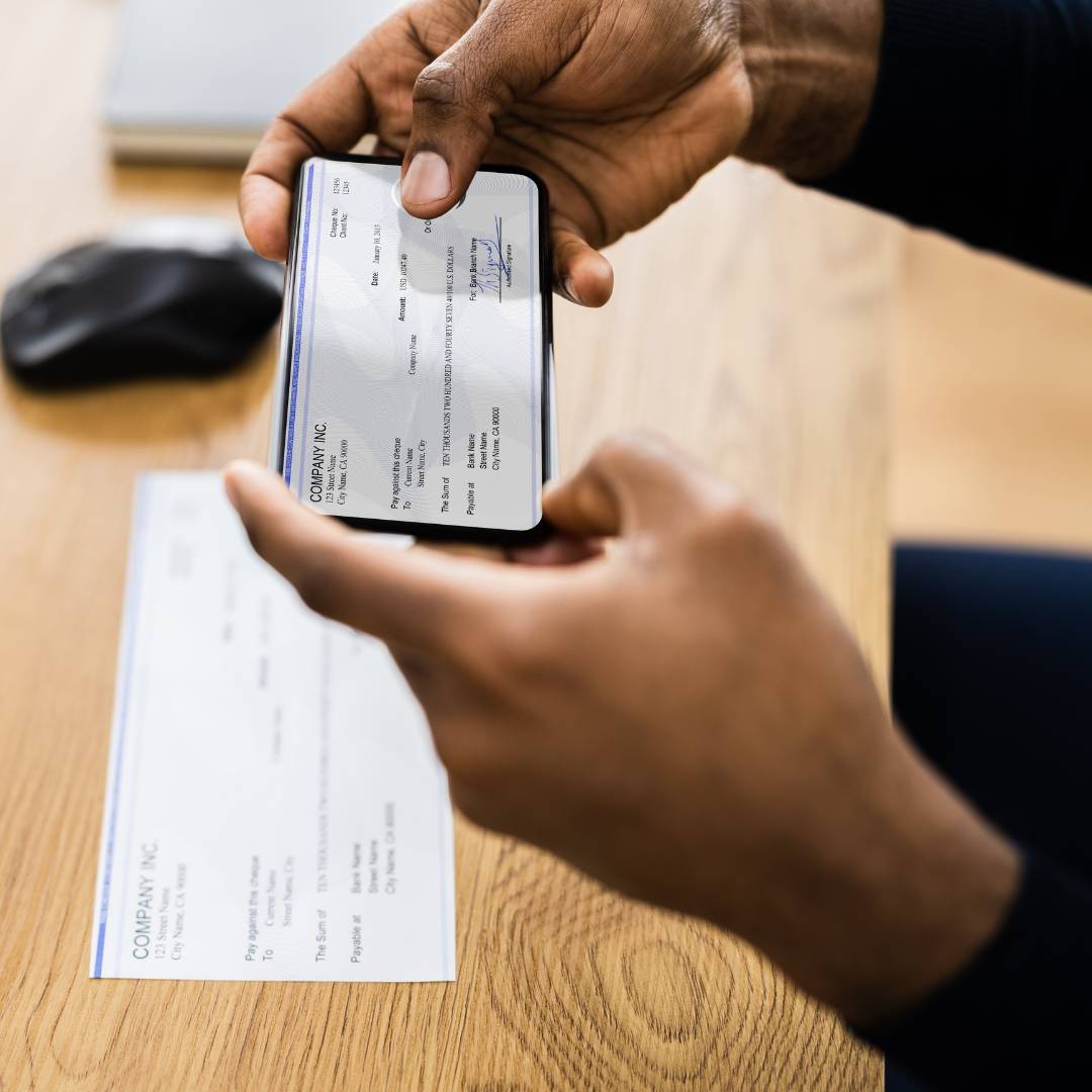 A person taking a picture of a check for deposit