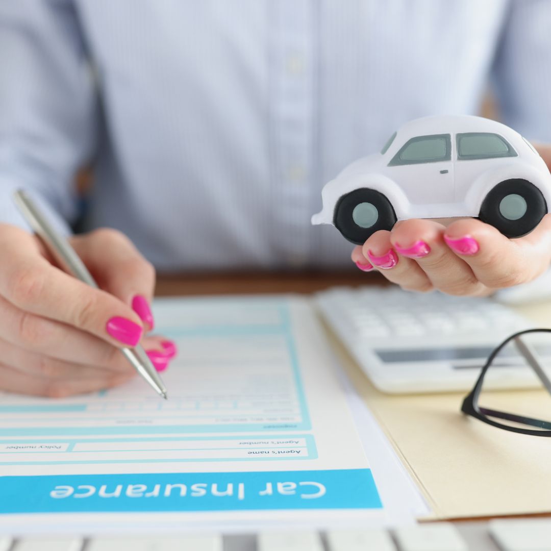 toy car with someone filling out an insurance claim