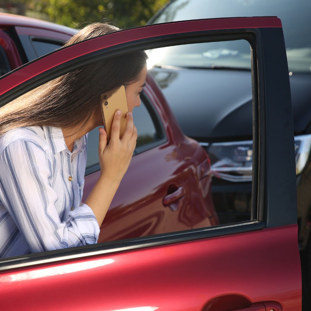 women on phone after a crash