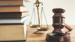 Judge mallet, a scale, and books