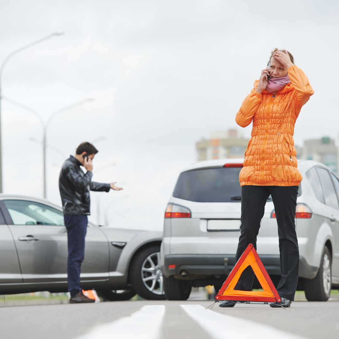 man and women viewing impact of car accident