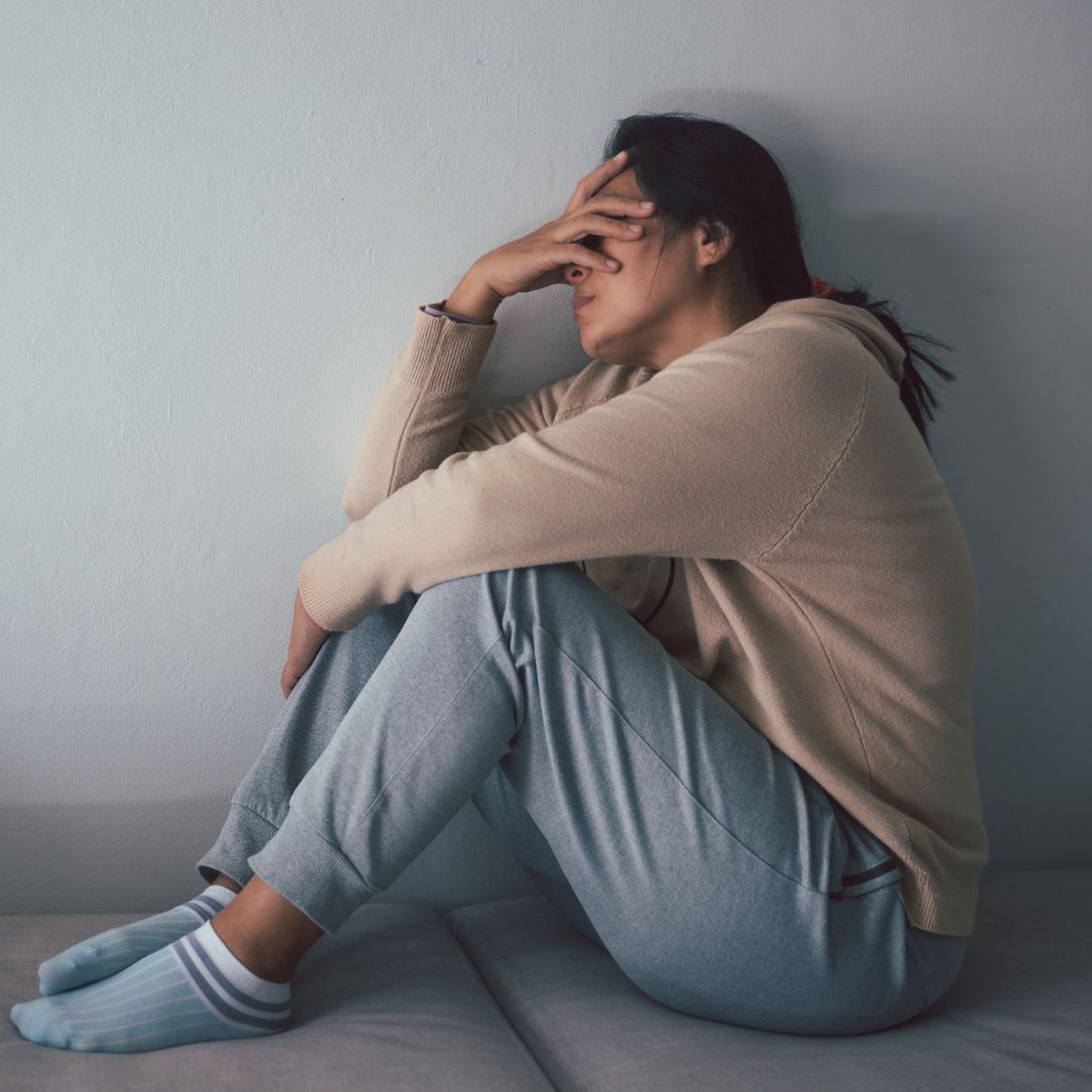 Women holding her head in frustration