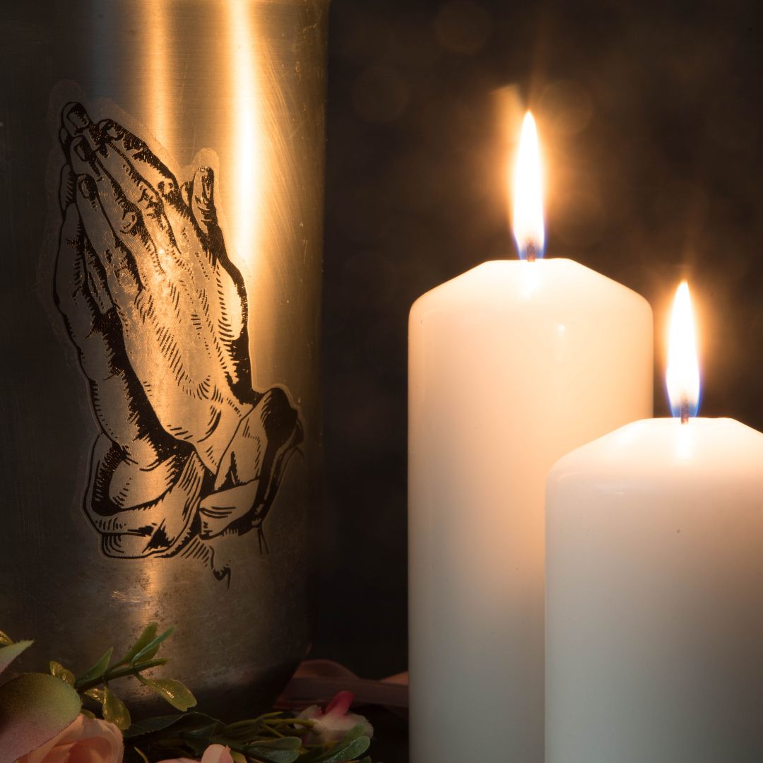 Candles with pictures of praying hands