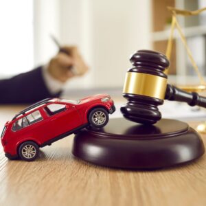 Toy car propped up on a gavel.