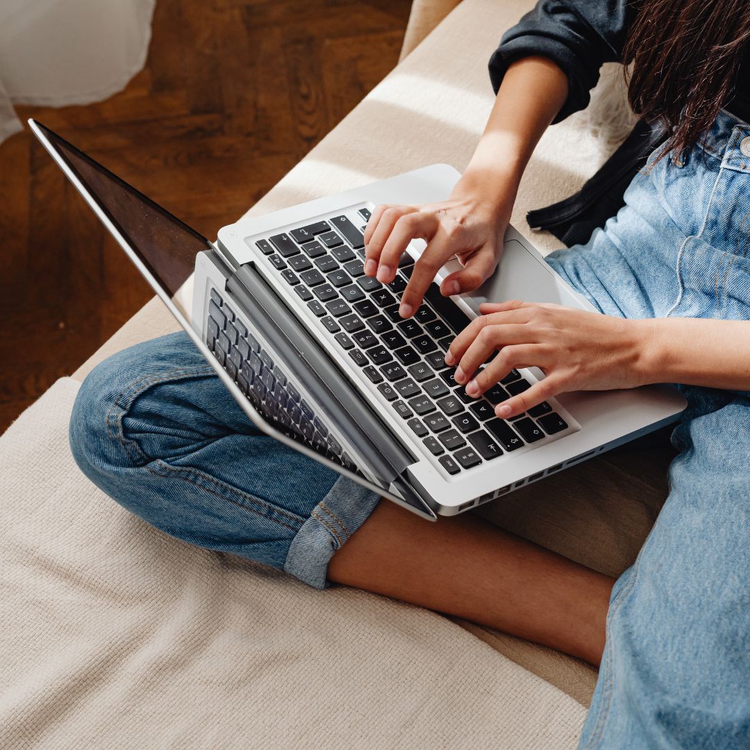 Woman typing on a laptop. 
