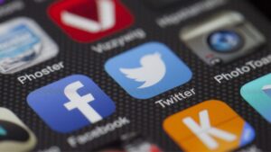 Phone screen showing various social media apps.