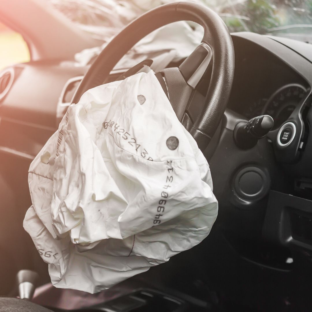 Deflated air bag coming out of a steering wheel. 