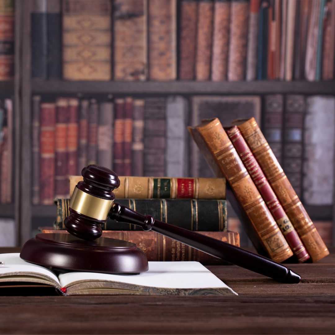 Lay books and a gavel on a desk. 