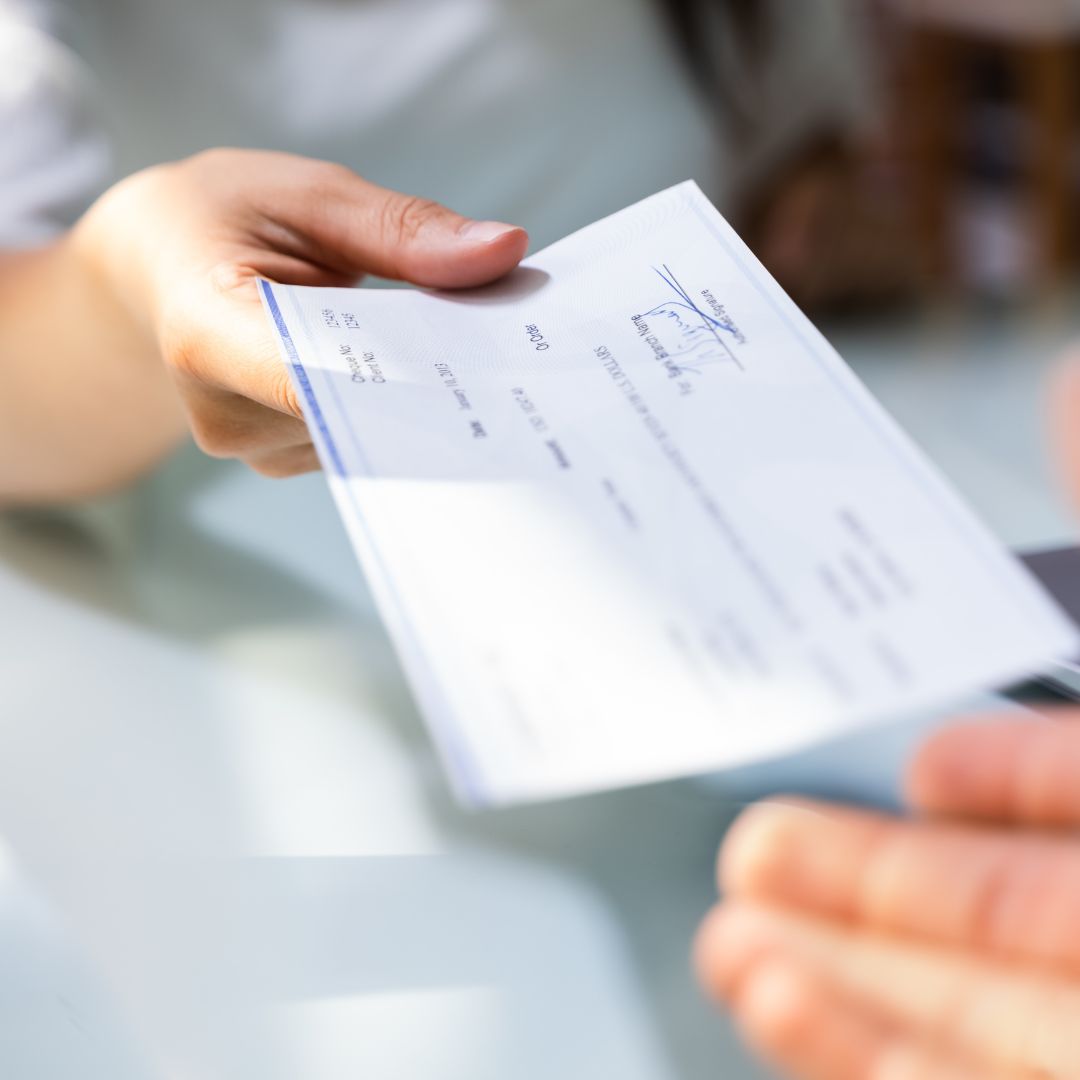 person handing over a check