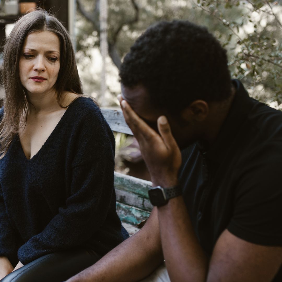 A couple crying as they break up