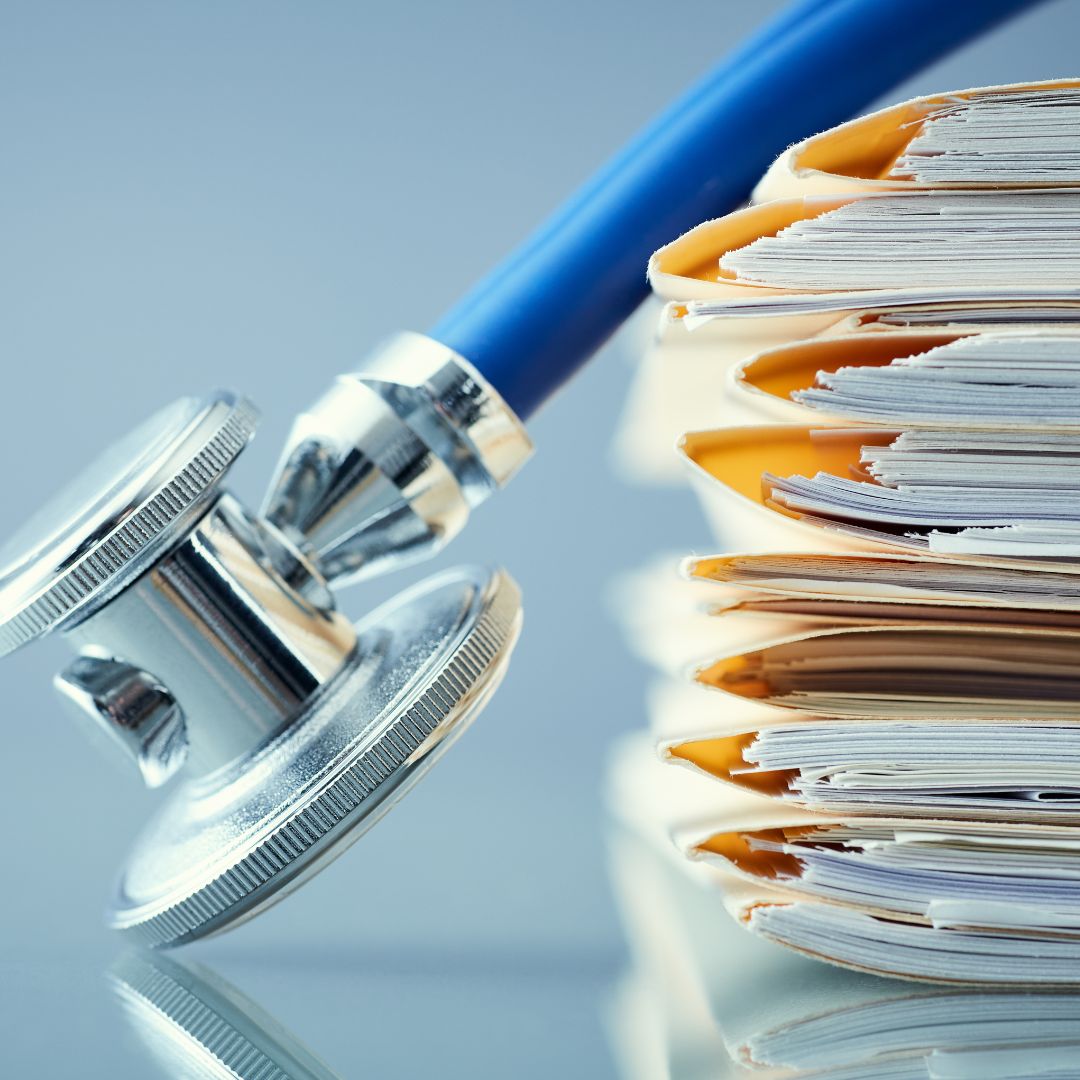 A stethoscope atop of some documents