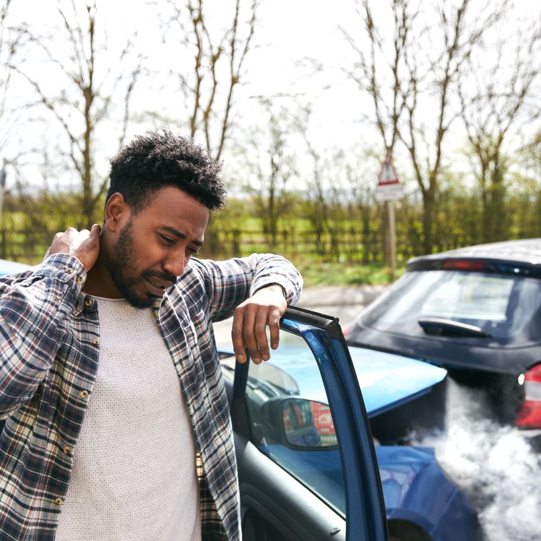 Man grabbing his neck after a car crash