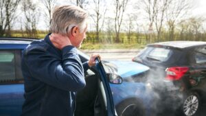 Man grabbing his neck after a car accident