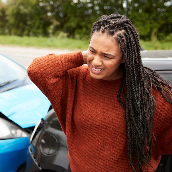 Women after a car crash holding her neck