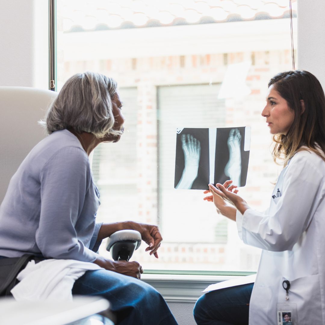 A woman at the doctor's looking at x-rays