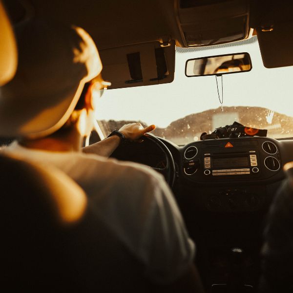 A man driving with the sun in his face