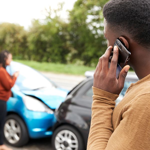 A man on the phone after a car accident