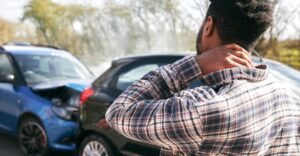 Man holding neck after car wreck