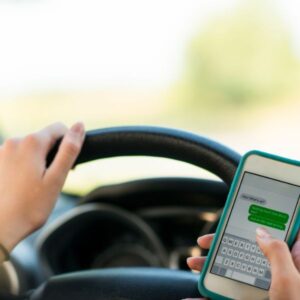 A person driving and texting