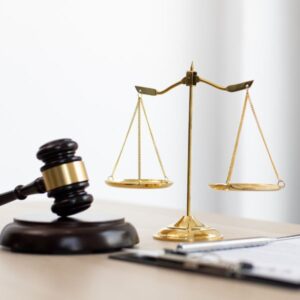 A judge gavel next to a scale