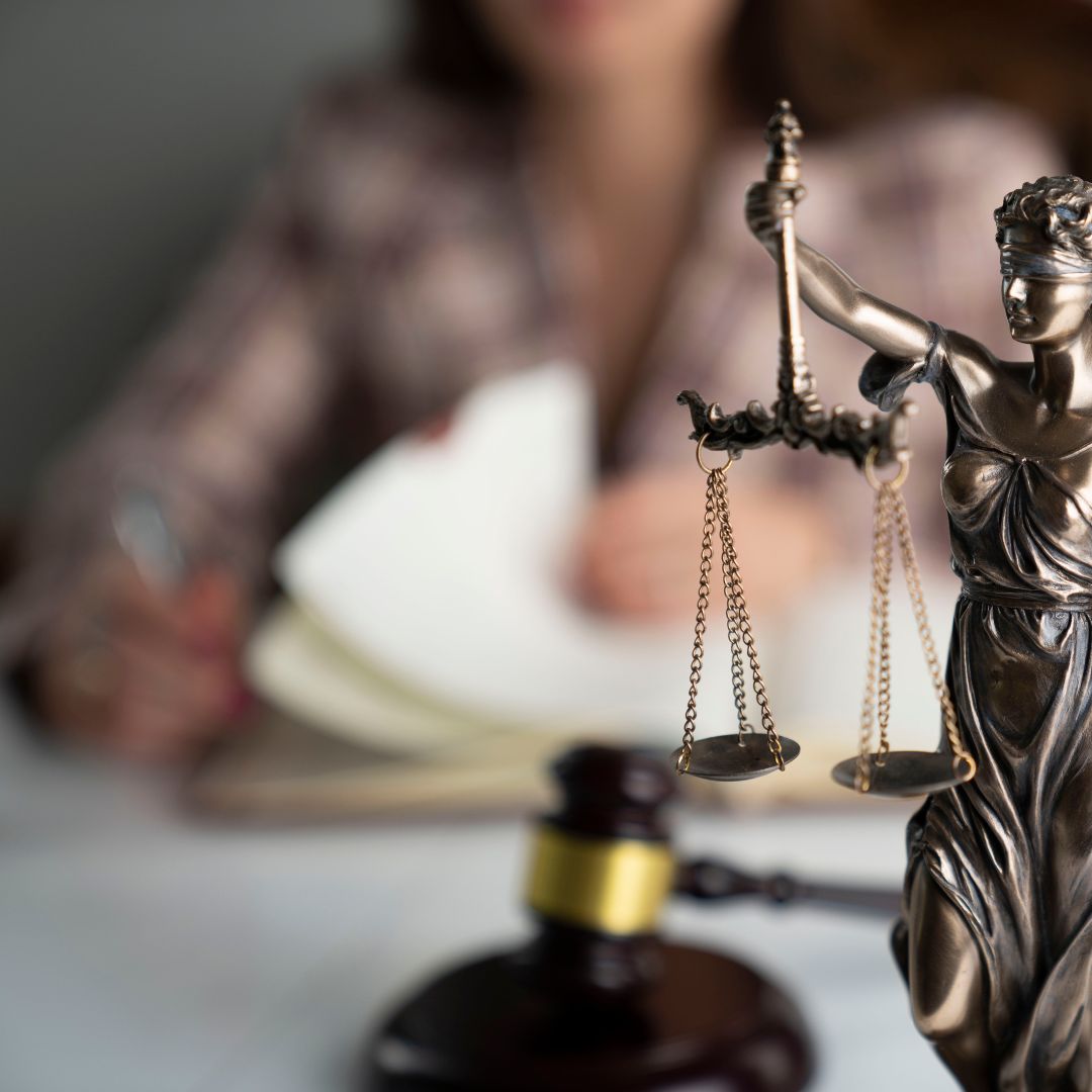 lady justice statue with attorney in background