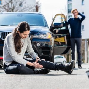 A man checking on a women after hitting her with his car