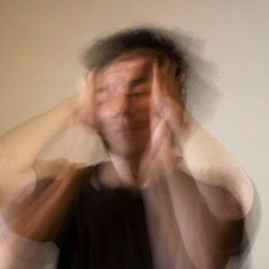 A man holding his head in an emotional state of mind