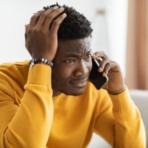 A stressed man on the phone