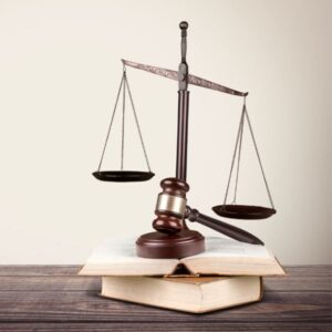 A balance scale next to a judge gavel