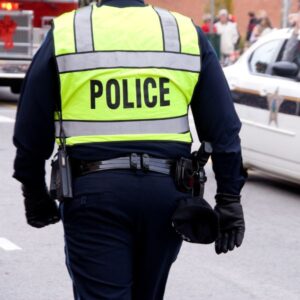 A police officer wearing a neon green vest