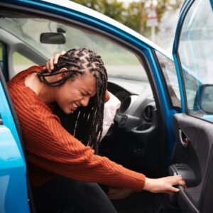 A women grabbing her neck in pain after a car crash