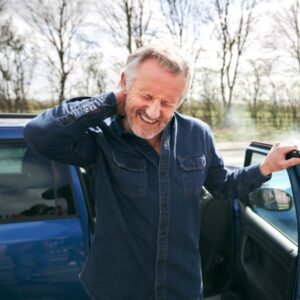 man grabbing his neck in pain
