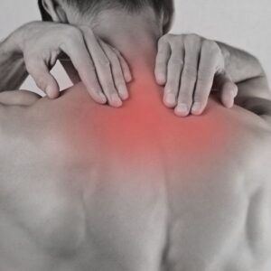 Person grabbing their upper back in pain