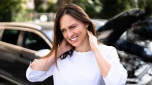 Women grabbing her neck in pain