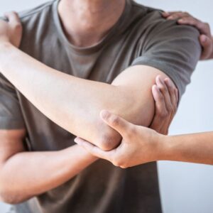 A person having their elbow examined