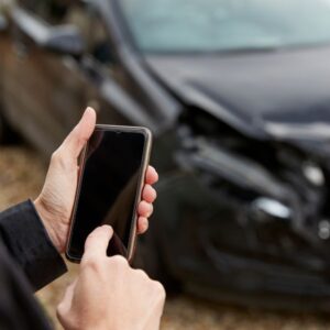A person taking a photo of their car accident