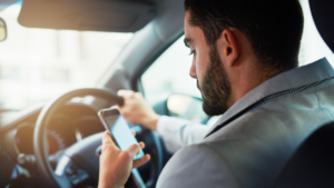 A person using their phone while driving