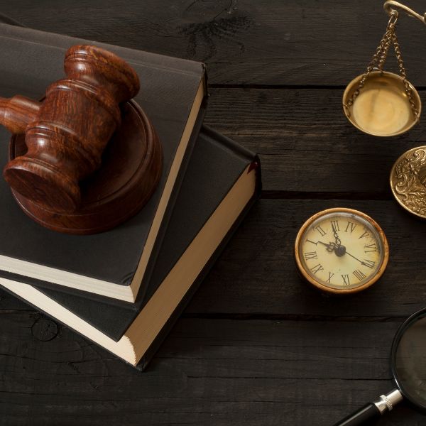 A set of law books with a judge gavel on top