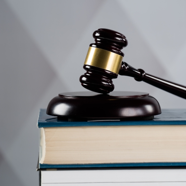 A judge gavel placed on top of books