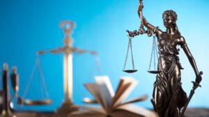 A statue of lady justice next to a sword
